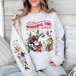 Beige retro Rudolph The Red-Nosed Reindeer Christmas hoodie with sleeve prints, featuring Bumble, Santa, and "The most wonderful time of the year" quote
