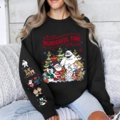 Beige retro Rudolph The Red-Nosed Reindeer Christmas hoodie with sleeve prints, featuring Bumble, Santa, and "The most wonderful time of the year" quote