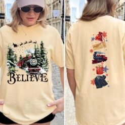 Black Christmas sweatshirt featuring a vintage train in a snowy forest with the word Believe, and Polar Express themed sleeve prints like a golden ticket and hot cocoa