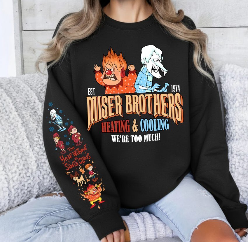 Light grey retro Christmas sweatshirt featuring Heat Miser and Snow Miser, Miser Brothers Heating and Cooling graphic, and character sleeve prints