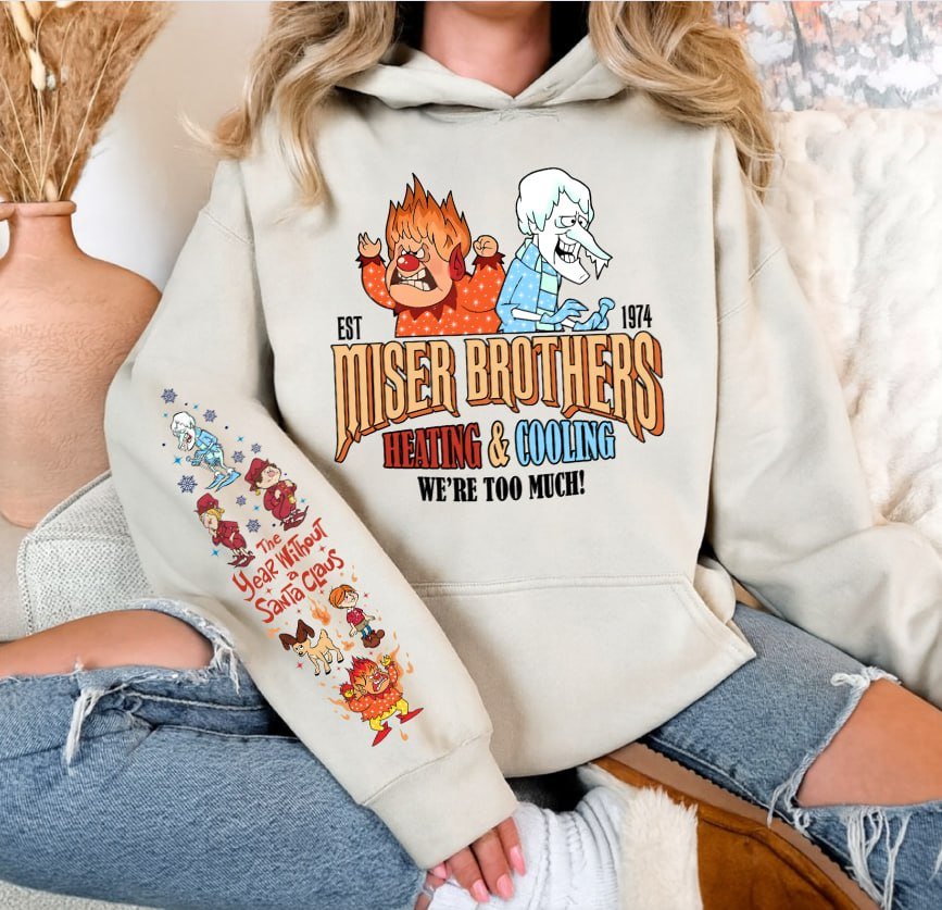 Light grey retro Christmas sweatshirt featuring Heat Miser and Snow Miser, Miser Brothers Heating and Cooling graphic, and character sleeve prints