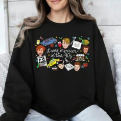White crewneck Christmas sweatshirt featuring a retro 90s holiday movie collage design with the text "it was merrier in the 90s" alongside nostalgic characters and icons