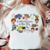 White crewneck Christmas sweatshirt featuring a retro 90s holiday movie collage design with the text "it was merrier in the 90s" alongside nostalgic characters and icons