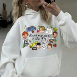 White crewneck Christmas sweatshirt featuring a retro 90s holiday movie collage design with the text "it was merrier in the 90s" alongside nostalgic characters and icons